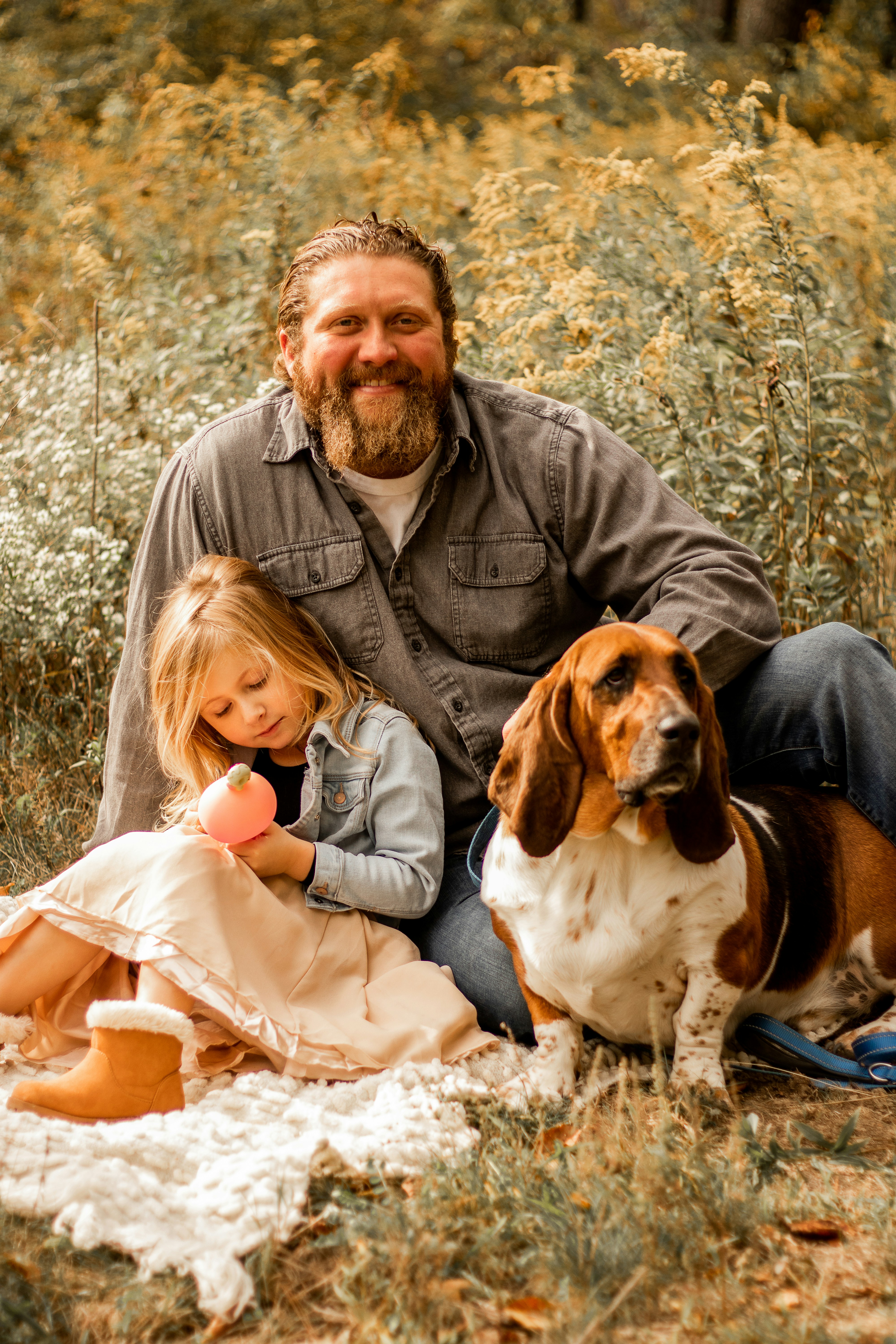 man in gray jacket carrying girl in white jacket