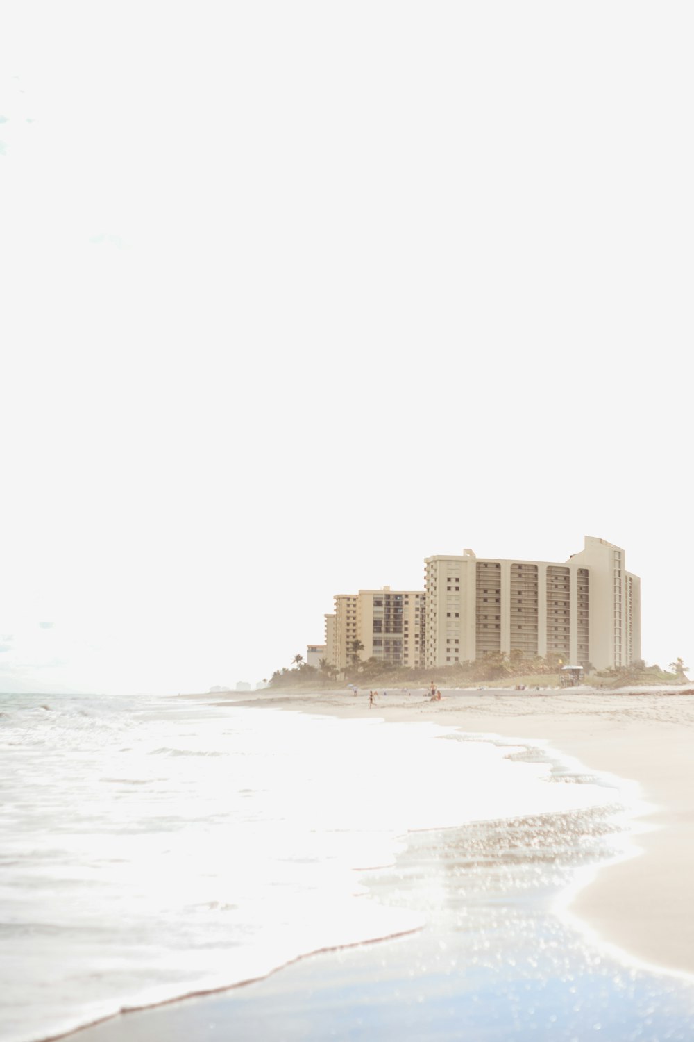 white concrete building near sea during daytime