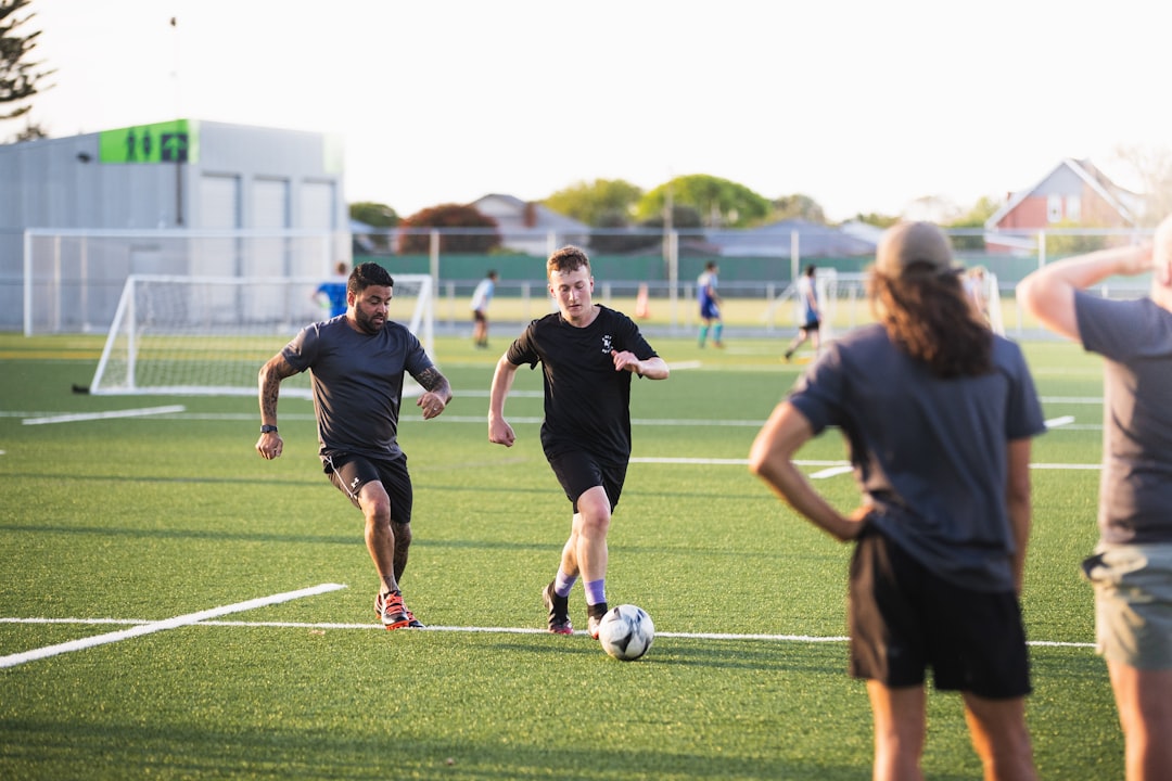 group of people playing soccer during daytime