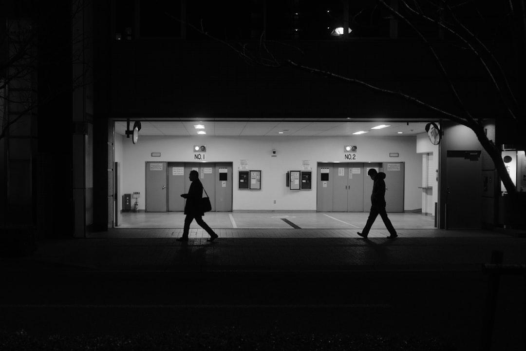 silhouette of man and woman walking on hallway