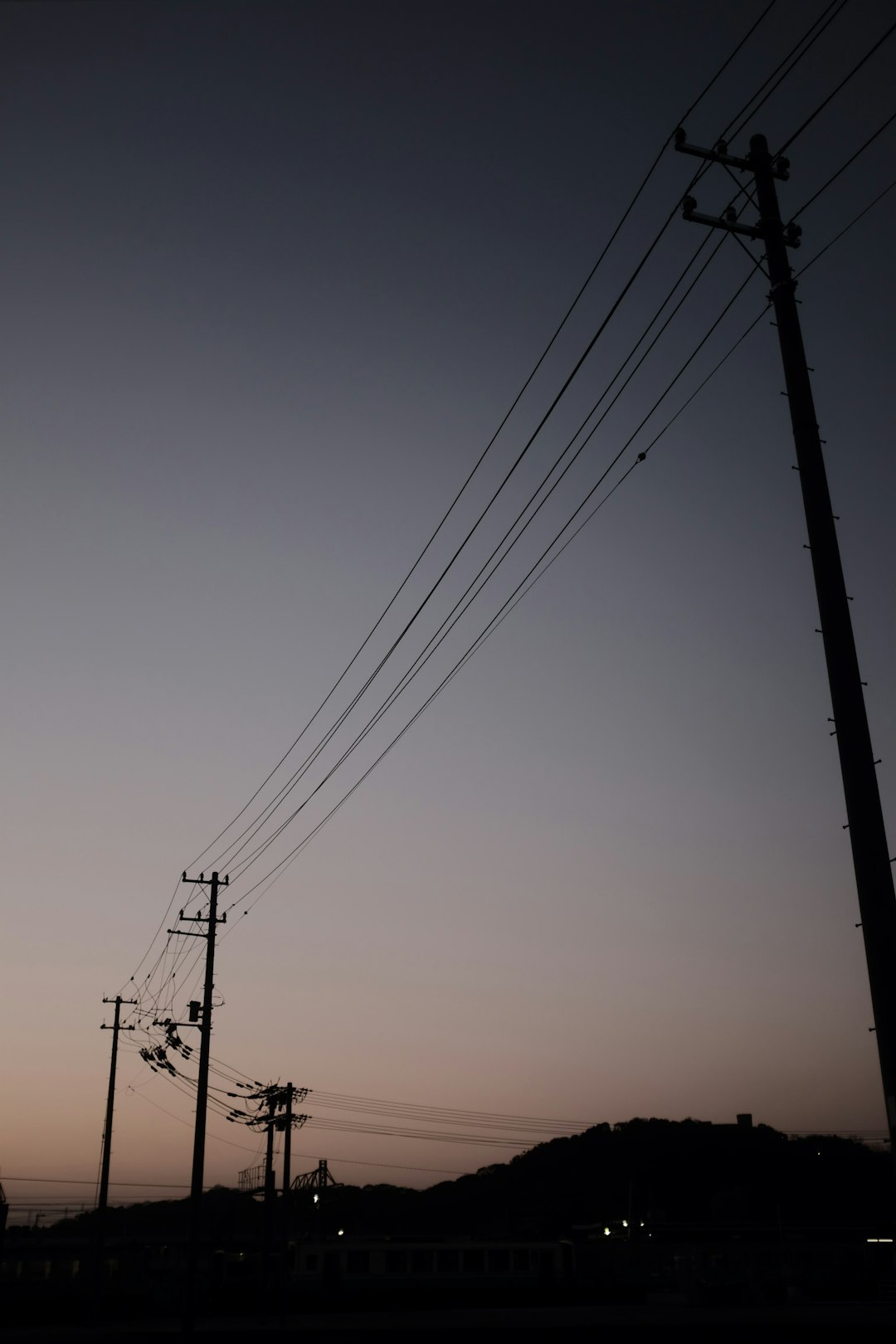 black electric post under blue sky during daytime