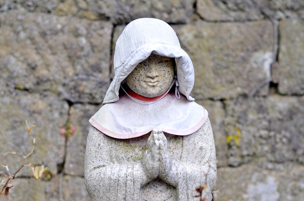 woman in white hijab and white dress statue