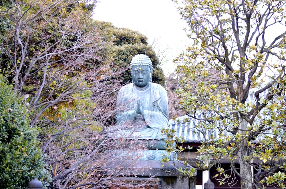 gray concrete statue on brown wooden table