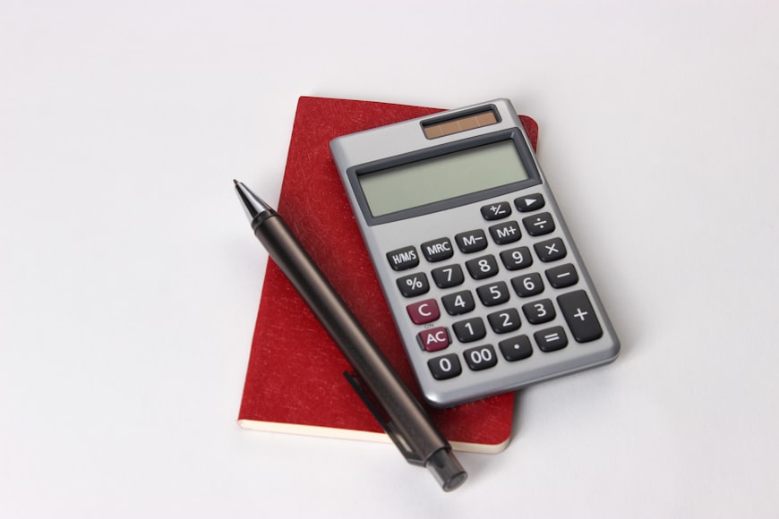 A calculator, pen and notebook