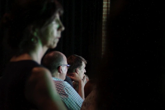 A warm, inviting scene of a small group attentively listening to a speaker in a cozy conference room.