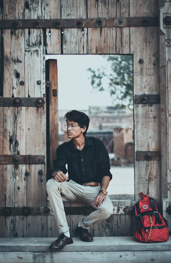 Man in a black polo and white trousers