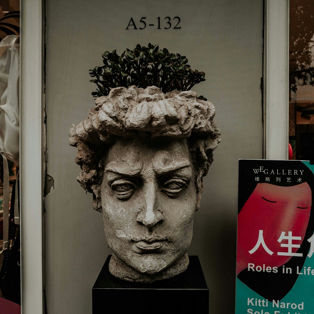 gray concrete head bust statue