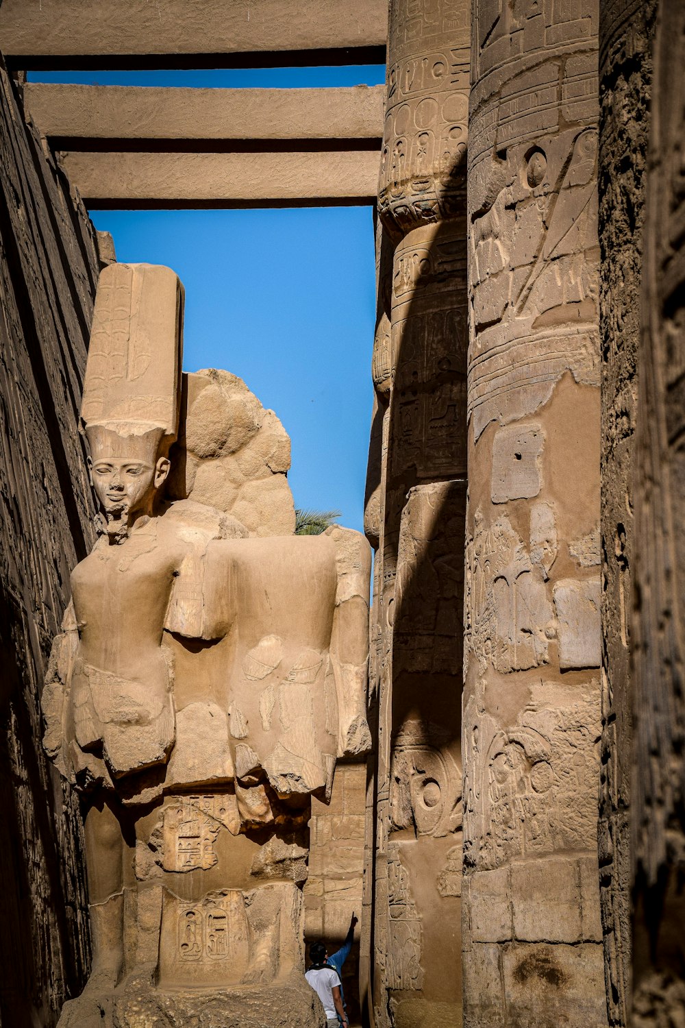 brown concrete statues under blue sky during daytime