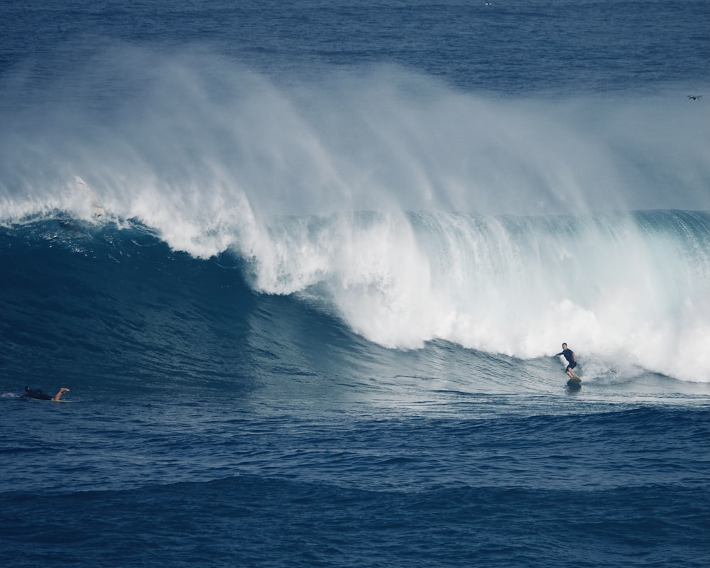 person surfing on sea waves during daytime