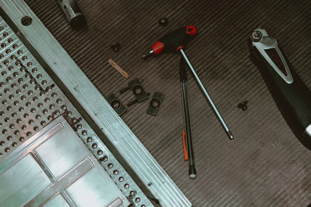 red and black metal tool,