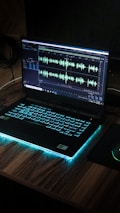 black laptop computer on brown wooden table