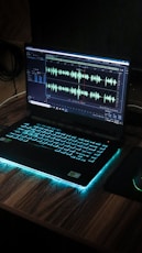 black laptop computer on brown wooden table