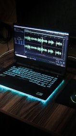 black laptop computer on brown wooden table