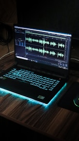 black laptop computer on brown wooden table
