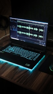 black laptop computer on brown wooden table