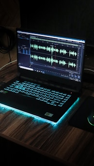 black laptop computer on brown wooden table