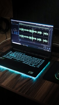 black laptop computer on brown wooden table