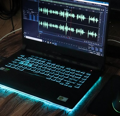 black laptop computer on brown wooden table