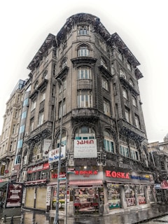 Street-level view of the Liberty Building with retail storefronts and apartment windows above.