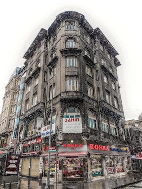 Street-level view of the Liberty Building with retail storefronts and apartment windows above.