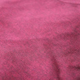 Close-up of a maroon saree fabric showing intricate handwoven patterns with gold threads.