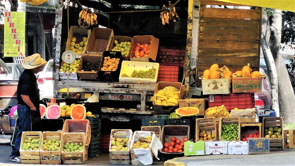 assorted fruits on black plastic crates