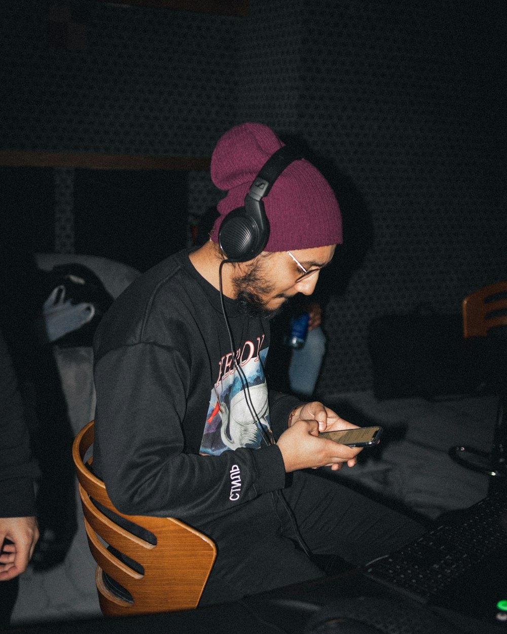 man in black and orange knit cap and black and red hoodie