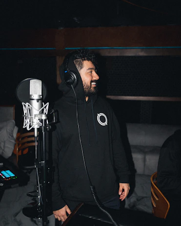 A candid moment of a singer smiling during a recording session.
