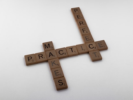 brown wooden cross on white surface