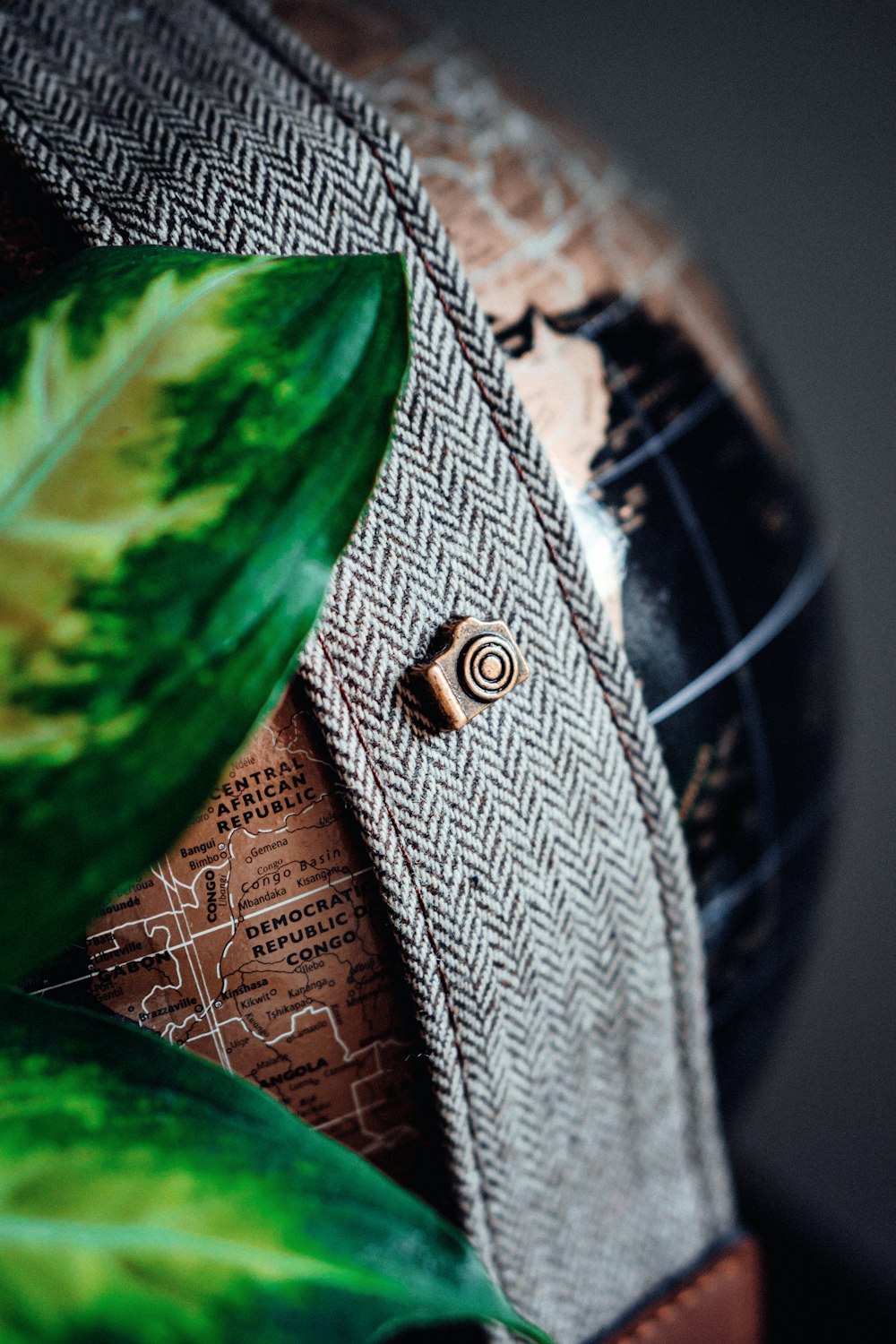 silver round coin on brown textile