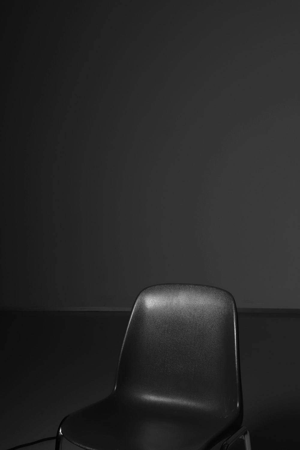 black leather chair on black surface