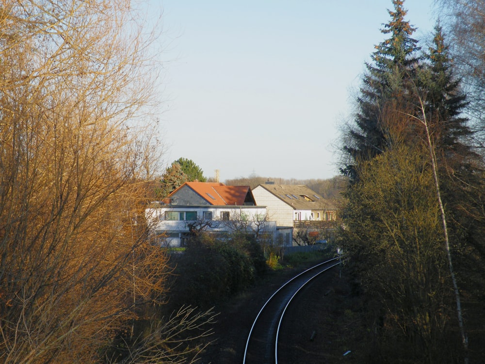 white and brown house near trees during daytime