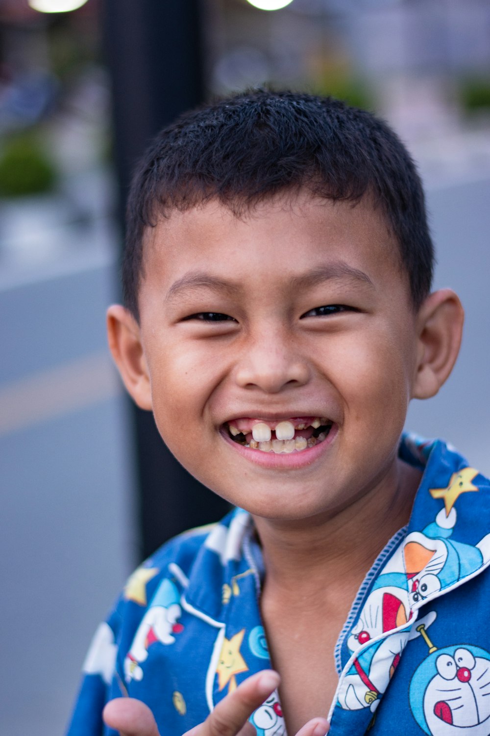 boy in blue and yellow crew neck shirt smiling