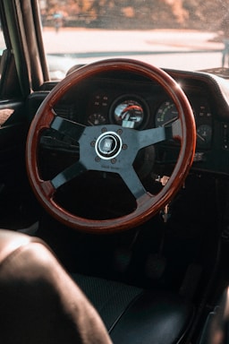 A vintage car dashboard with classic gauges and a warm sunlight glow.