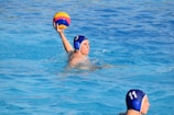man in blue swimming goggles in swimming pool