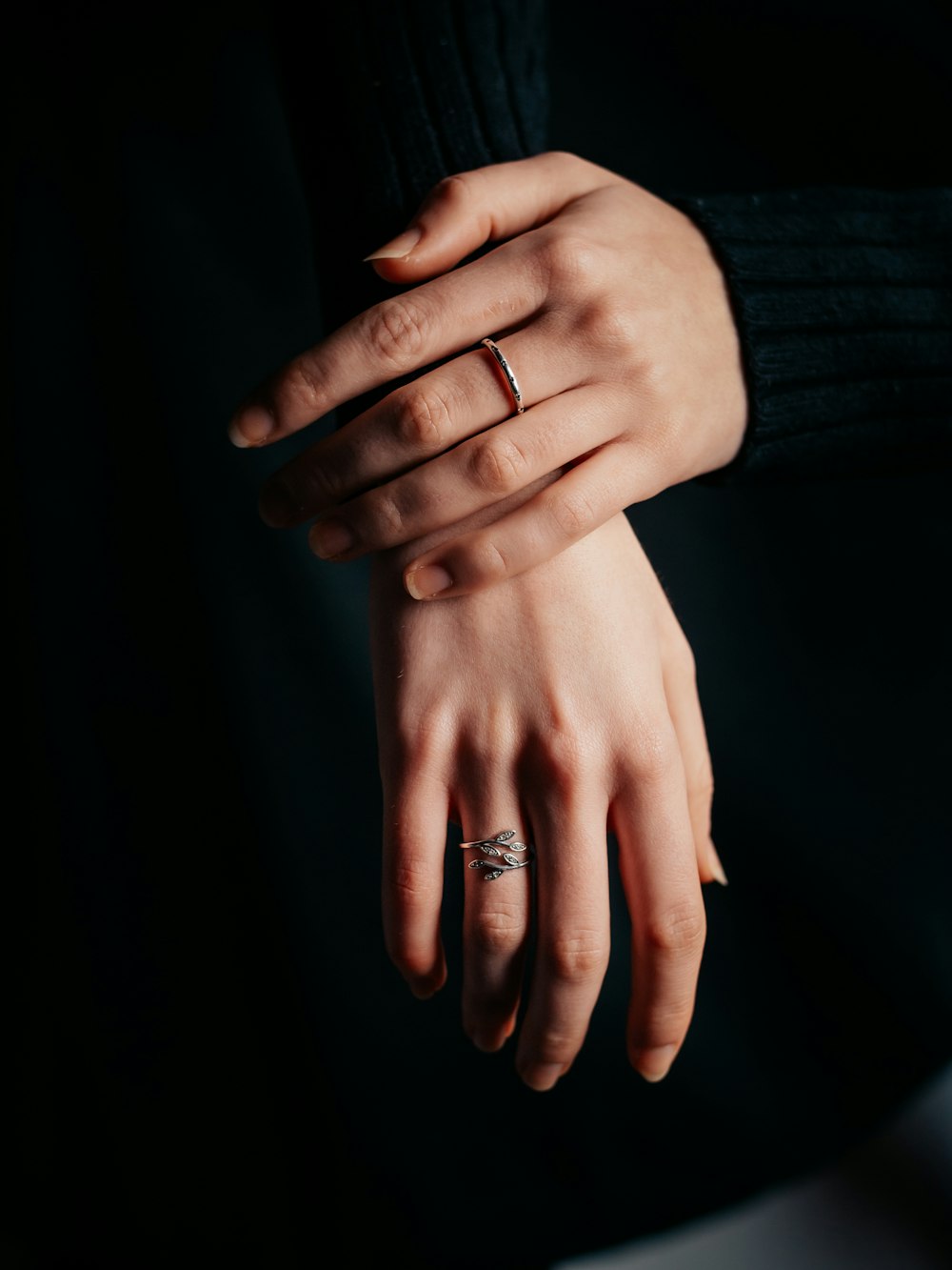 person wearing silver ring and ring