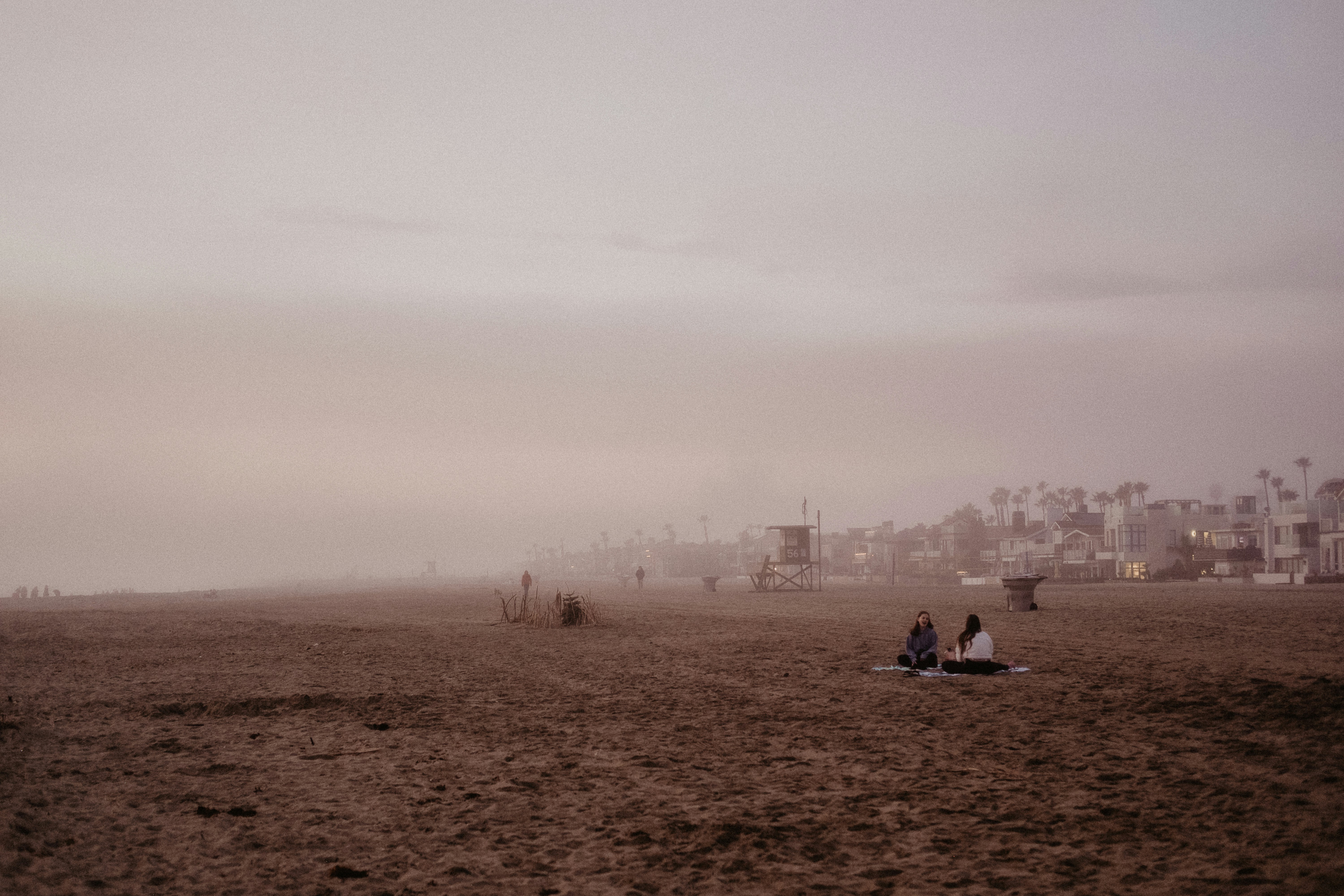 people sitting on brown field during daytime