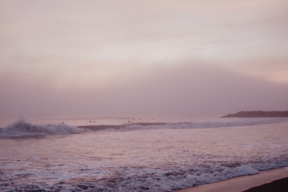 ocean waves crashing on shore during daytime