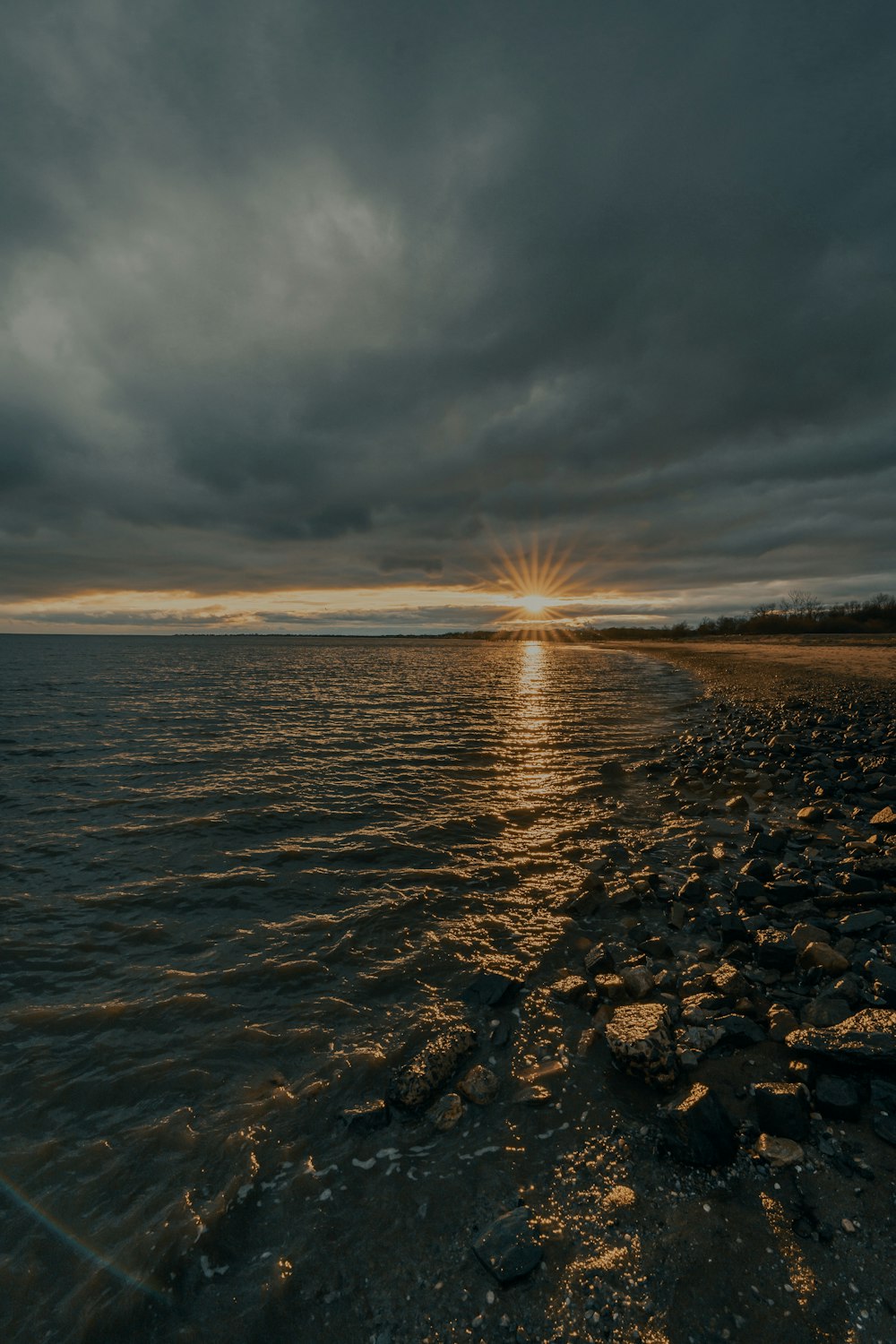 body of water under cloudy sky during daytime