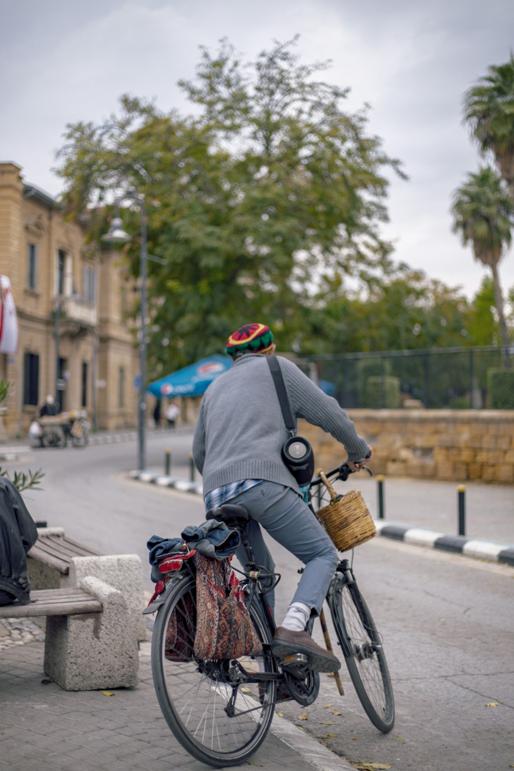 person in black jacket riding bicycle on road during daytime