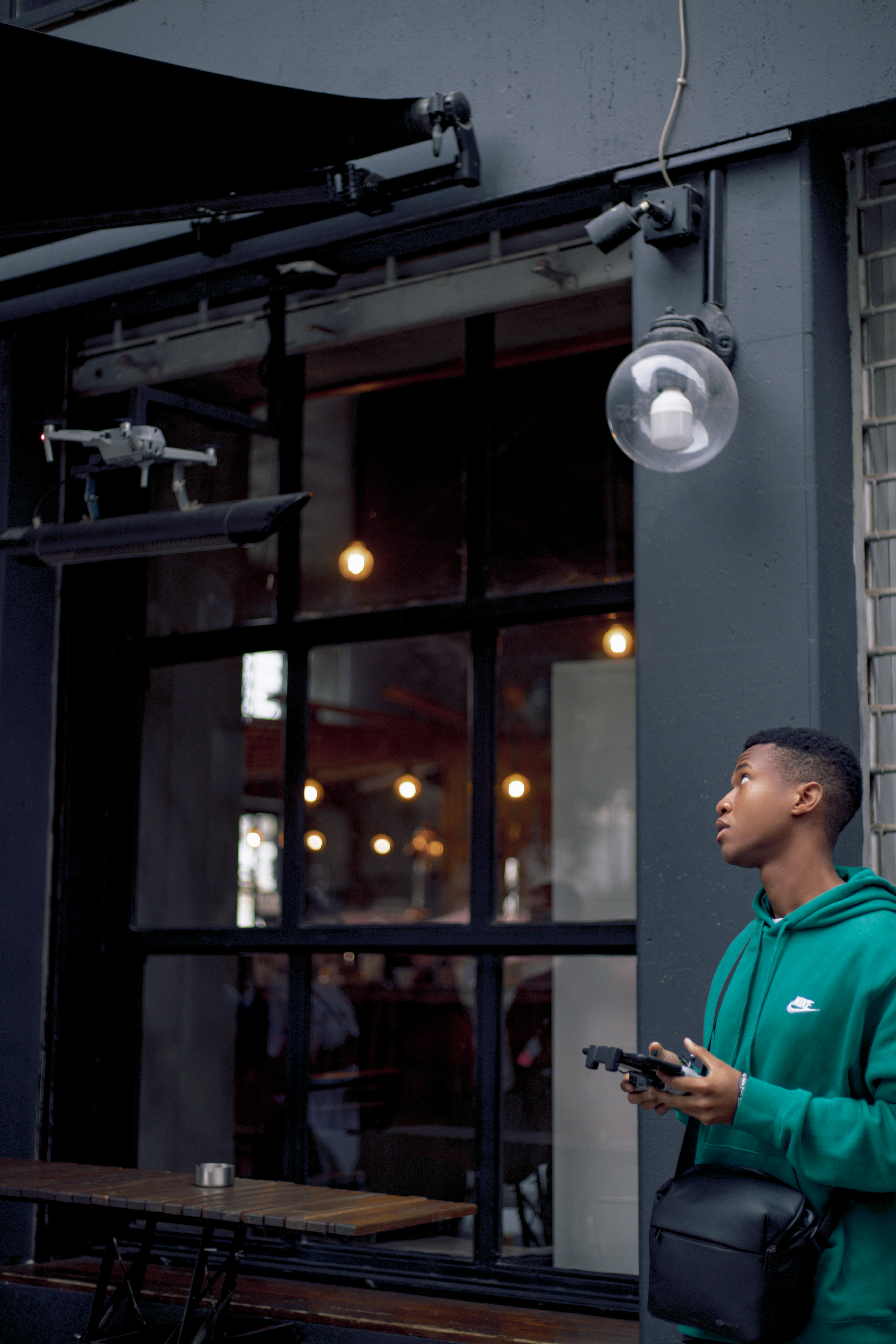 man in blue polo shirt standing near glass window