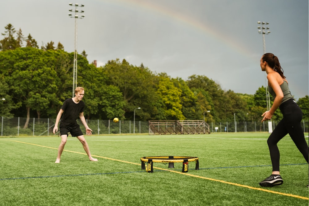 man in black shirt playing soccer during daytime