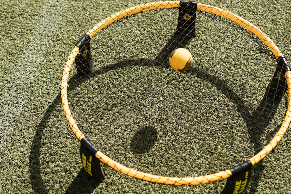 yellow round ball on black and white net