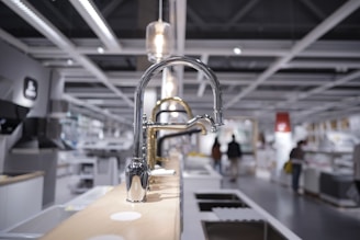 stainless steel faucet on brown wooden table