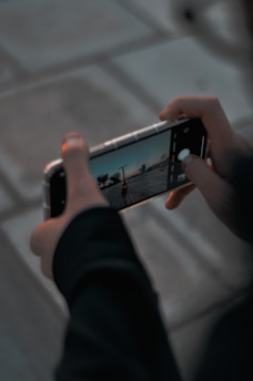 person holding silver iphone 6