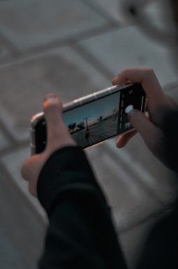 person holding silver iphone 6