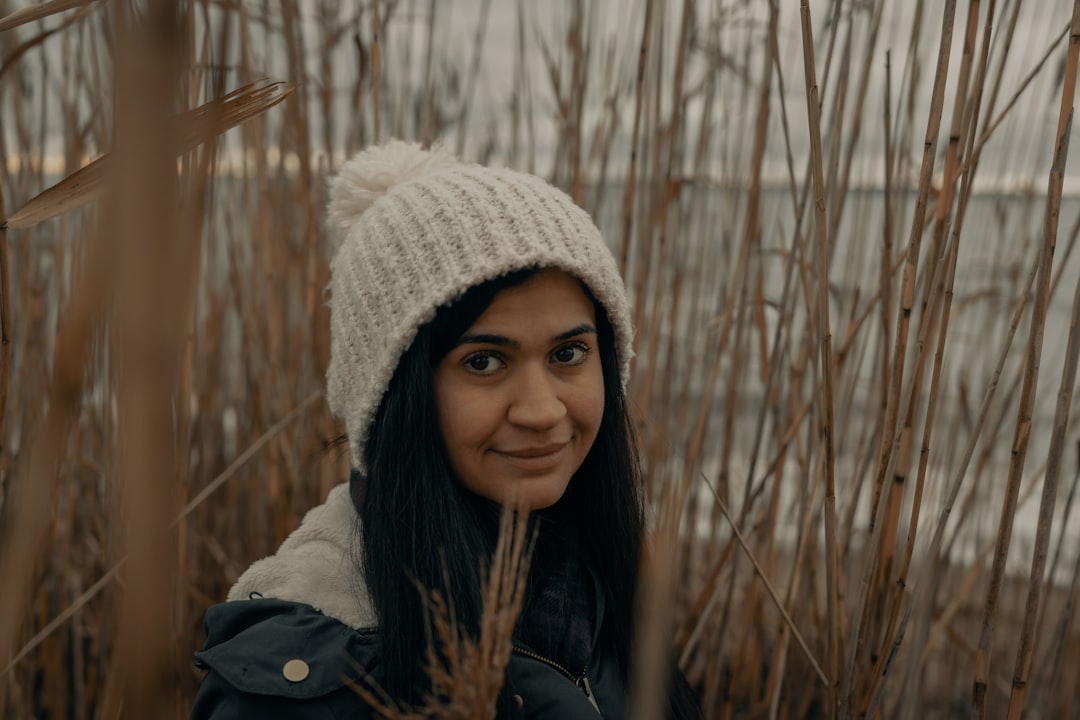 woman in white knit cap and black leather jacket