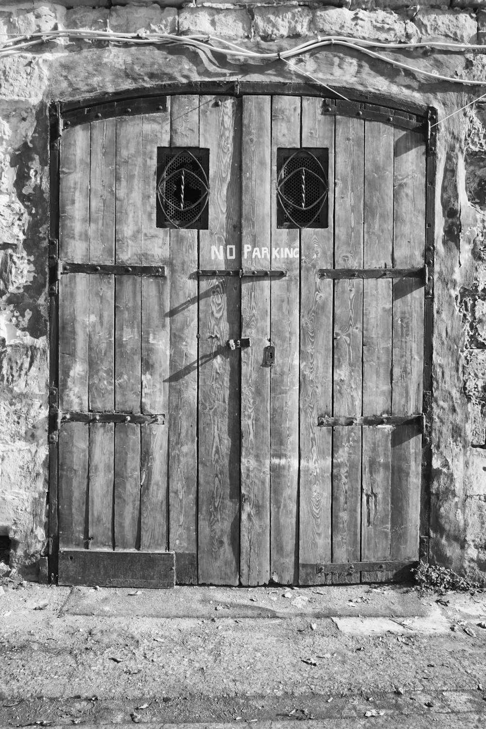 grayscale photo of wooden door