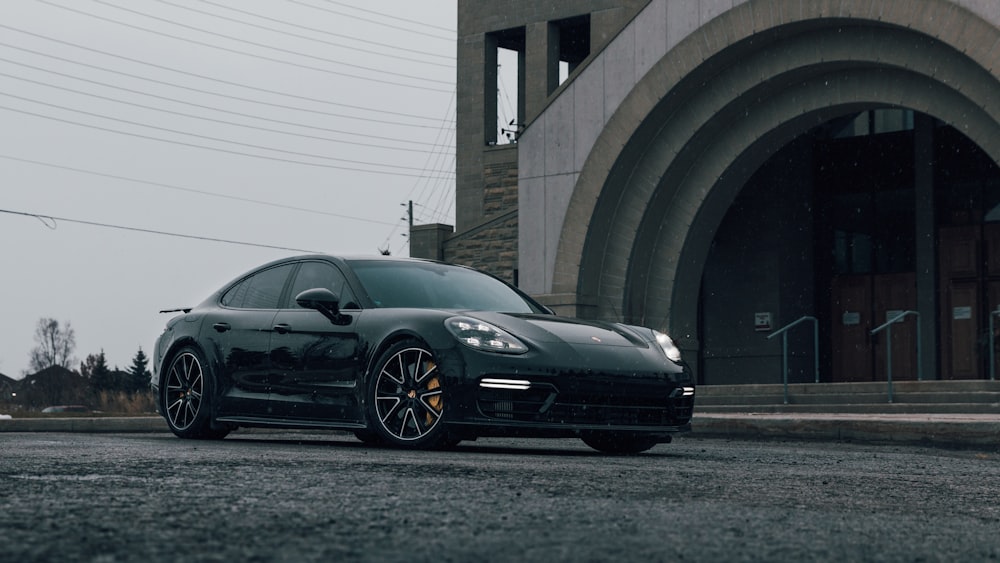 black coupe parked near building