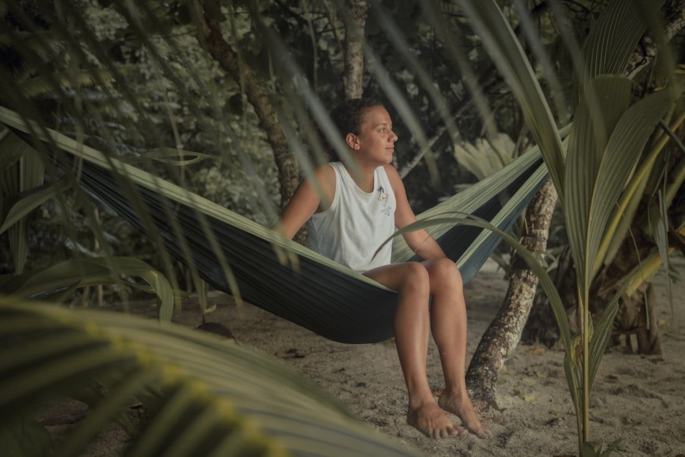 woman in white shirt sitting on hammock